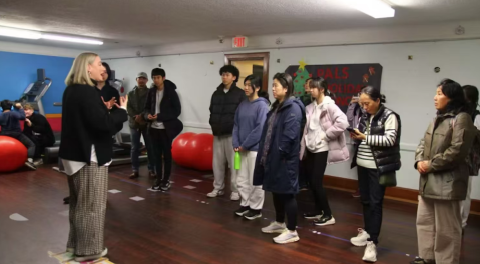 A group listening to a speaker during a visit to PALS
